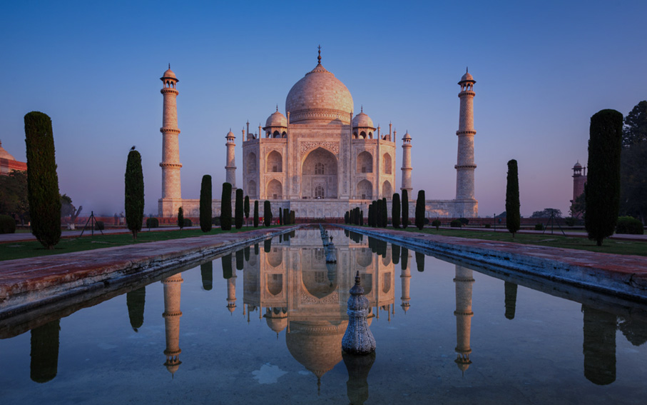 The Taj Mahal reflected in its long pool at dusk