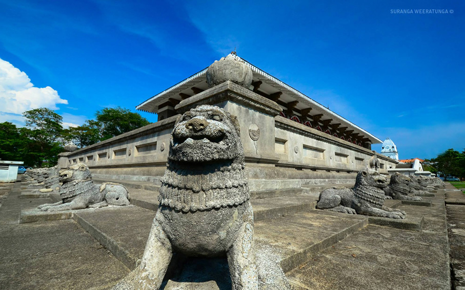 Carved stone lions guarding a historic Sri Lankan landmark